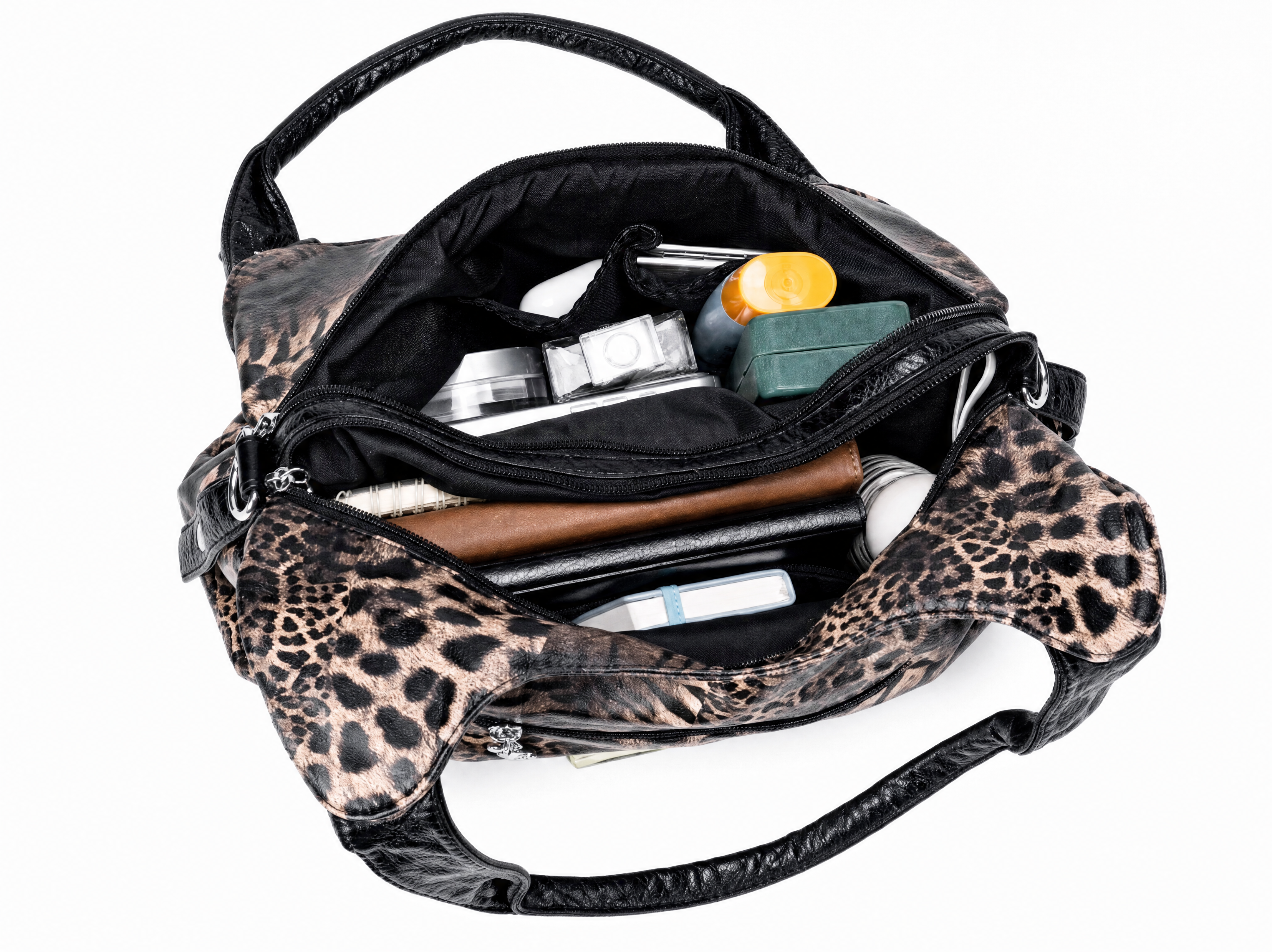 Bag open from above, main compartment packed with a wallet, phone and makeup